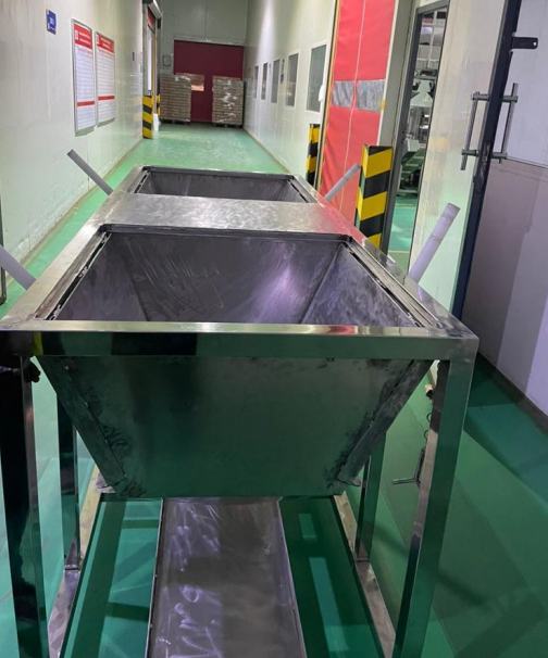 Stainless steel hopper trolley in a factory
